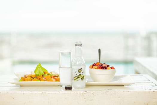 a desk with healthy snacks and a water bottle